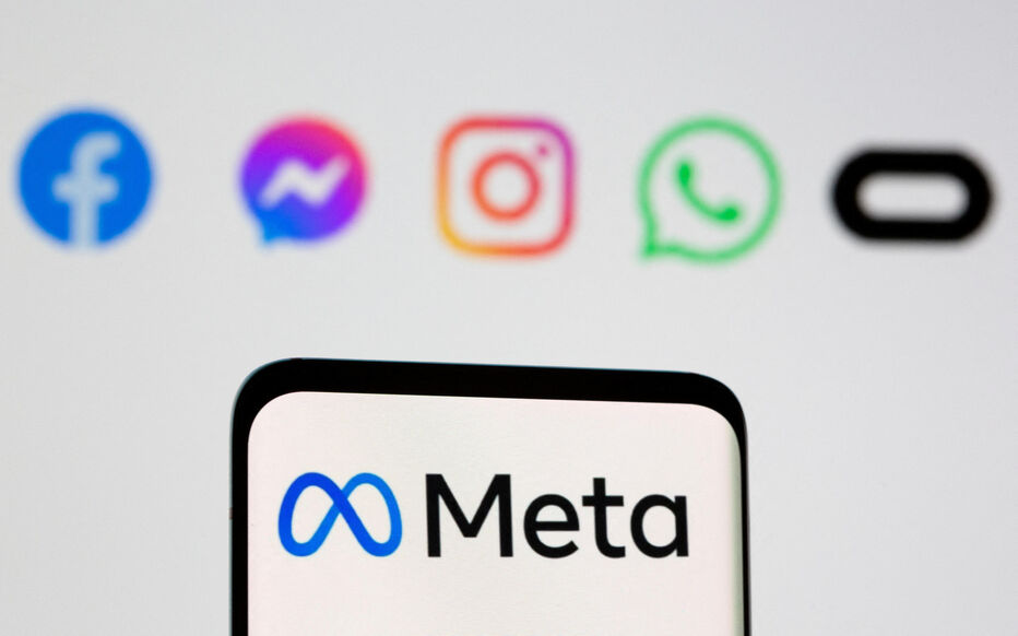 FILE PHOTO: The Meta logo is seen on smartphone in front of displayed logo of Facebook, Messenger, Instagram, WhatsApp, Oculus in this illustration taken