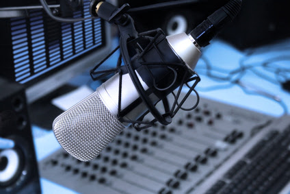 A mic in front of the control panel in broadcasting studio